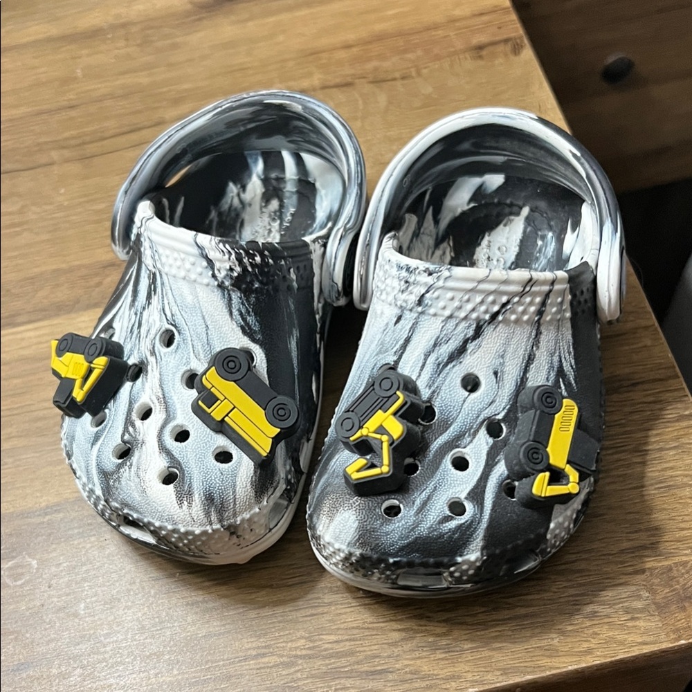 CROCS Kids Black and White Marble Clogs with Yellow Truck Charms